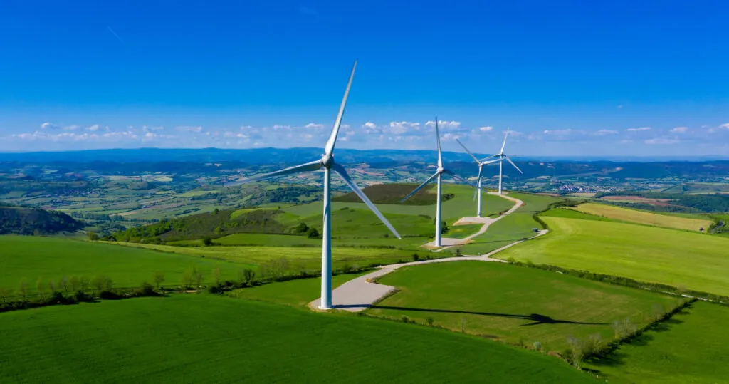 Wind turbines across green fields and agricultural land